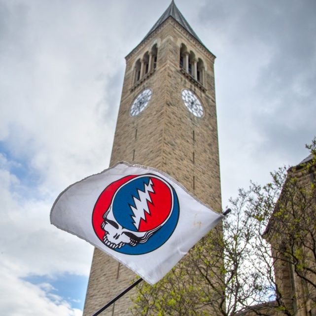 Cornell clock tower with Grateful Dead flag in foreground