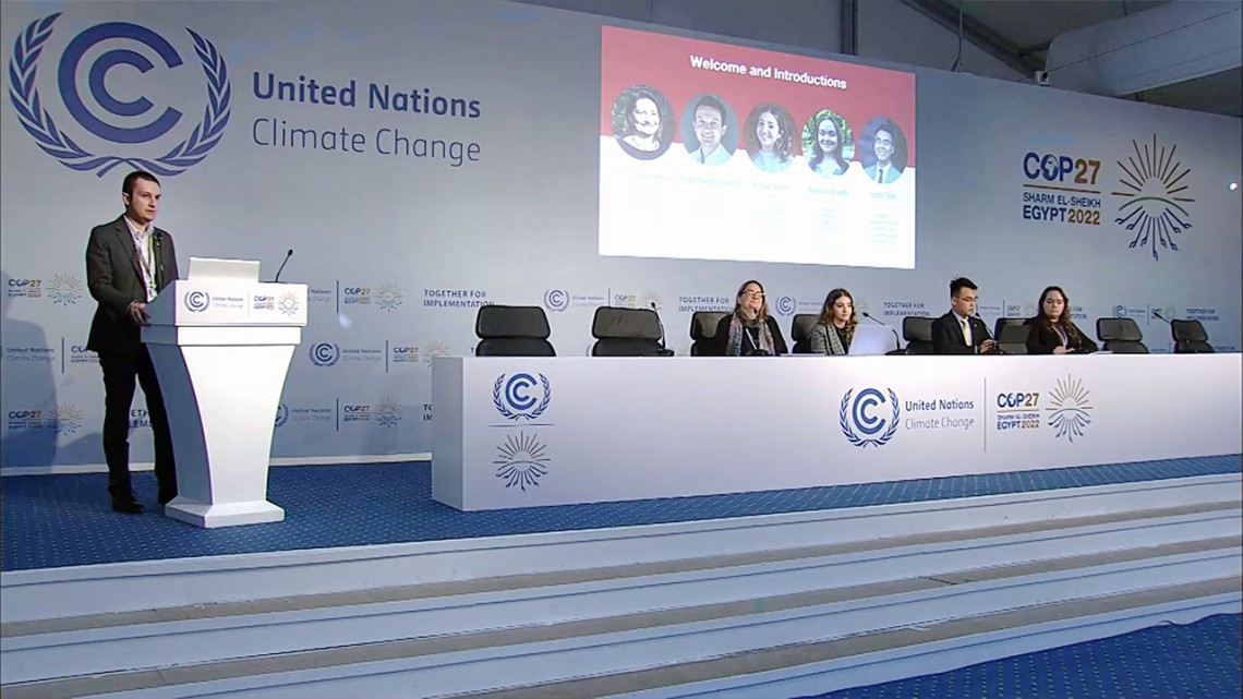 Nick Hamp-Adams, a student in the Cornell Jeb E. Brooks School of Public Policy, leads a news conference at the annual U.N. climate summit