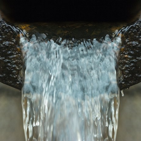 Freshwater runs out of large metal pipe