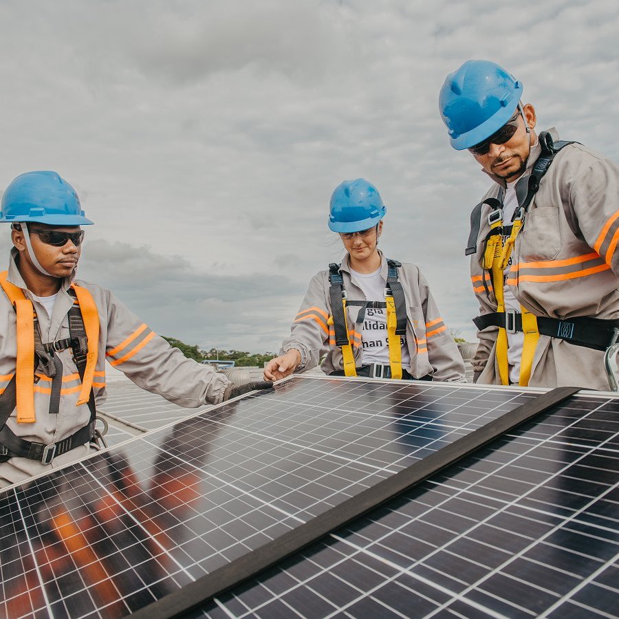 Workers installing solar panels