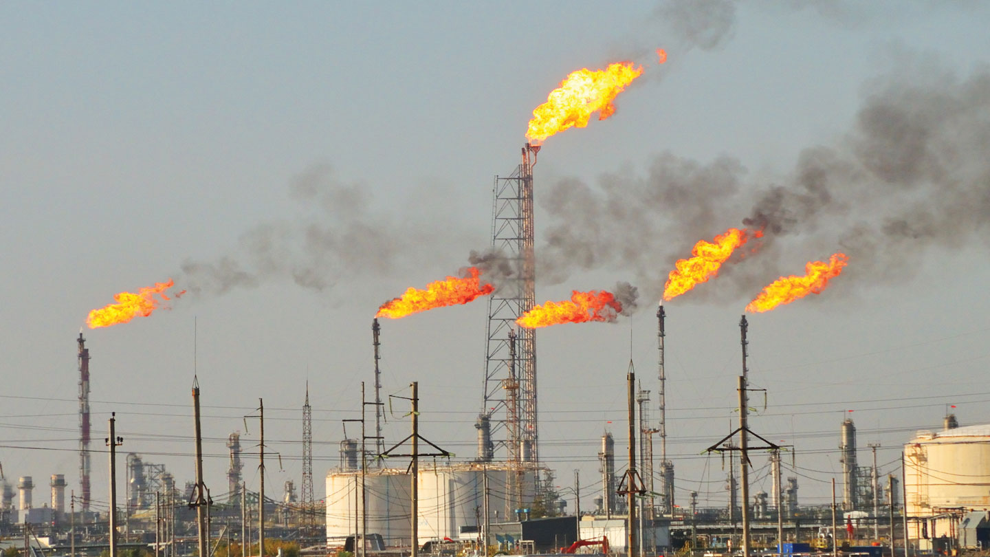 Factory smokestacks emitting gas flames