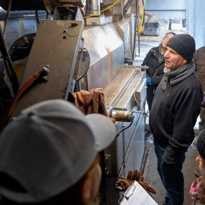 Johannes Lehmann examines biochar kiln at Spruce Haven Farm with officials from NYSERDA in November.
