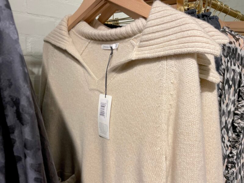 Women's sweaters hanging on a rack