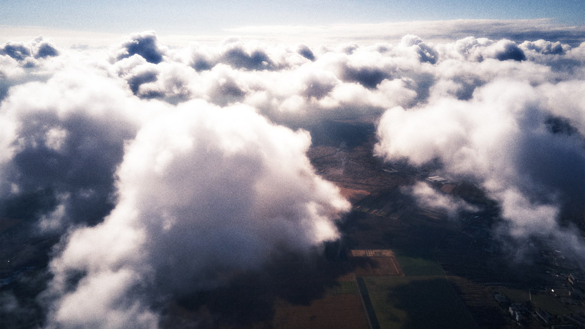 Aerial view of clouds hovering over farmland [Photo: Bilanol/iStock/Getty Images Plus]
