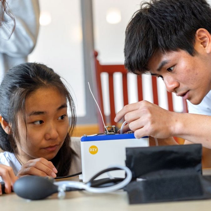 Max Zhang's students set up their all-in-one device that transmits blood pressure data via low-frequency radio waves.