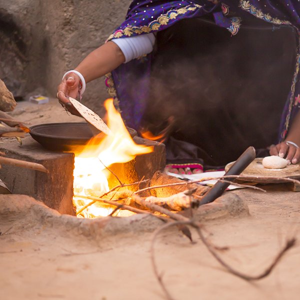 Woman preparing chapati in traditional Indian village kitchen (iStock)