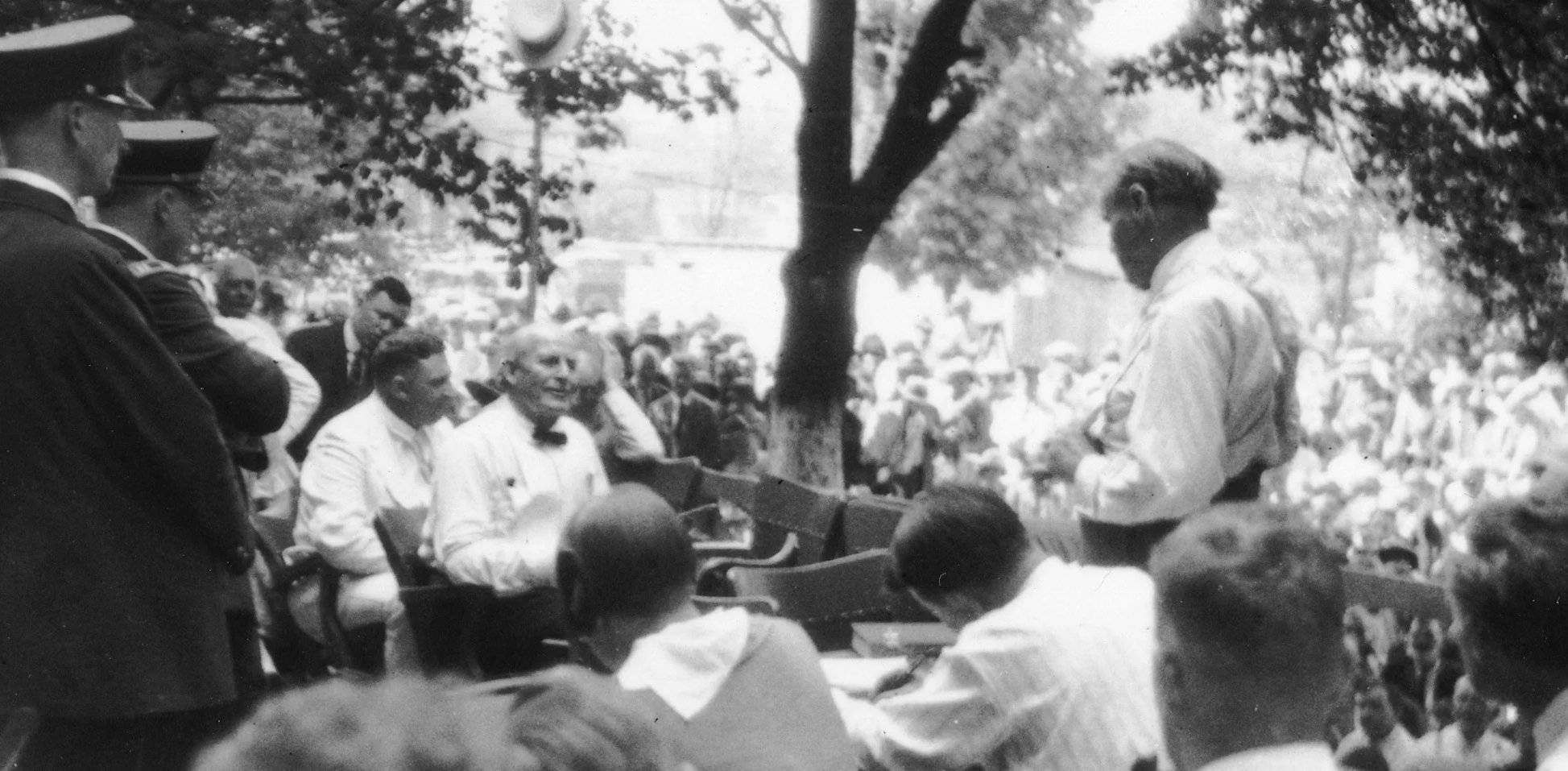 On the Scopes trial's seventh day, proceedings were moved outdoors because of excessive heat. William Jennings Bryan (seated, left) is being questioned by Clarence Darrow. (source: Wikipedia)