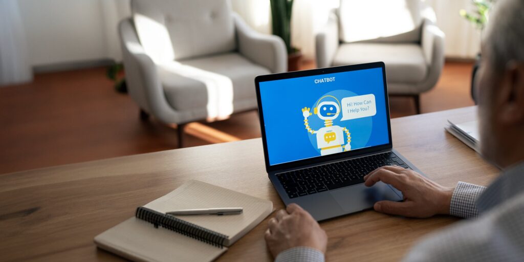 Senior man interacting with an ai chatbot on a laptop computer (iStock)