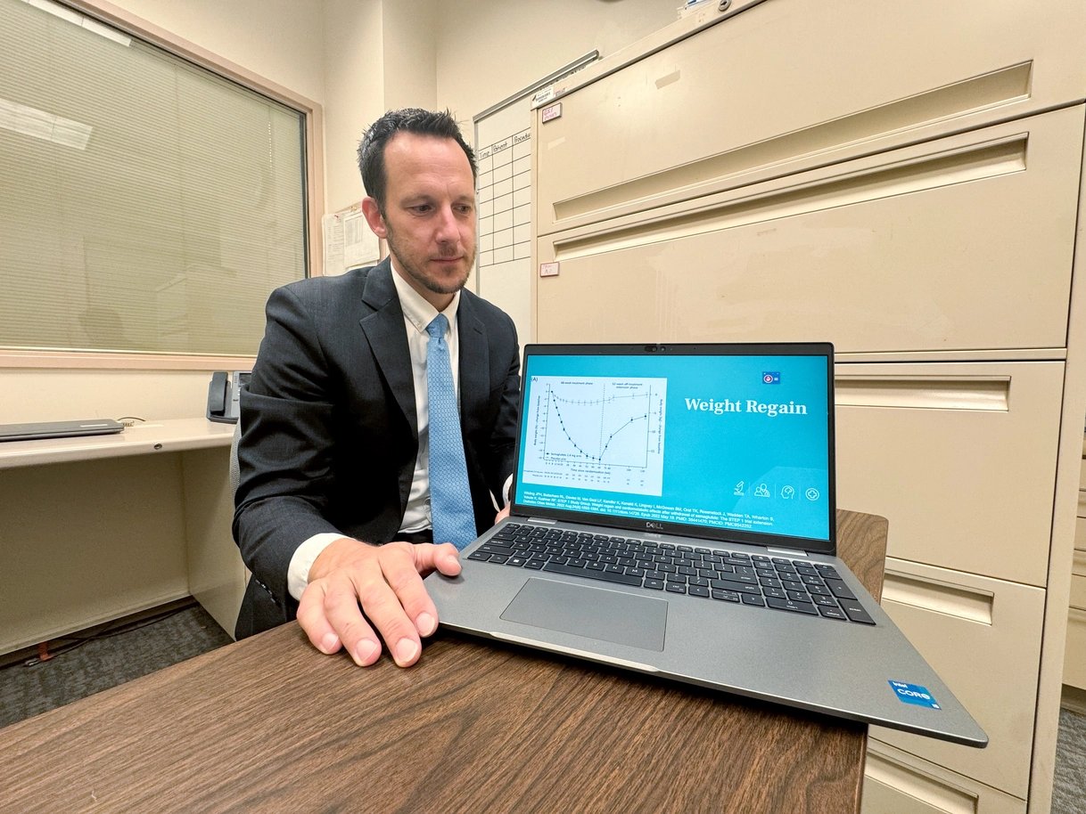 Wisconsin obesity medicine specialist Christopher Weber displays a chart showing patient weight regain patterns after stopping a GLP-1 treatment. | Kelly Hooper/POLITICO