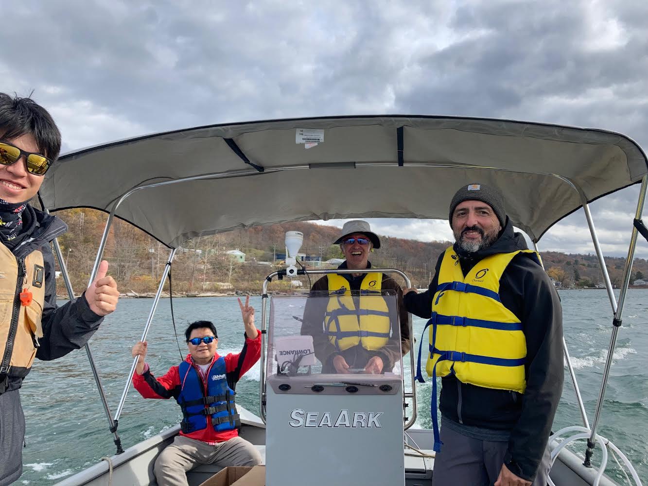 Todd Cowen, Jose Andres, and student researchers in motorboat on Cayuga Lake