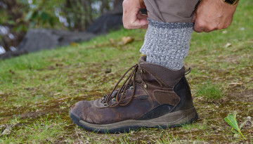 Hiker pulling socks up over pant leg