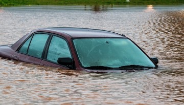Car mostly submerged in flooded street