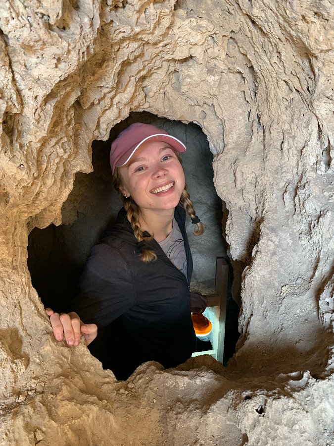 Anna Whittemore looks out from a cave