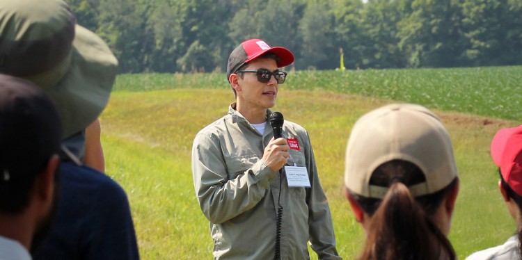 Louis Longchamps speaking with farmers